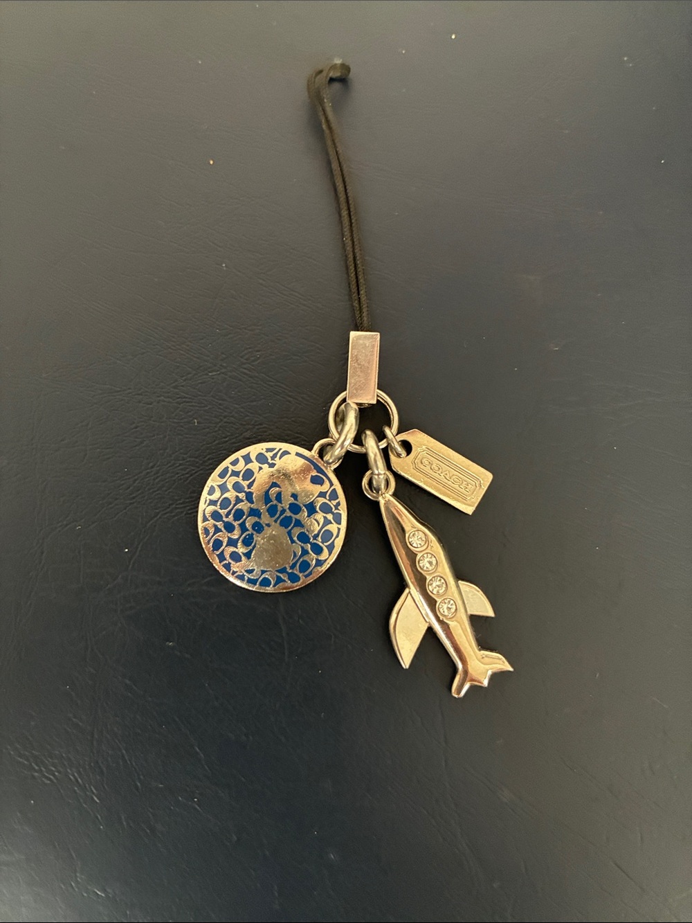 Coach Gold-Tone Airplane & Enamel Medallion Phone Charm with Black Strap